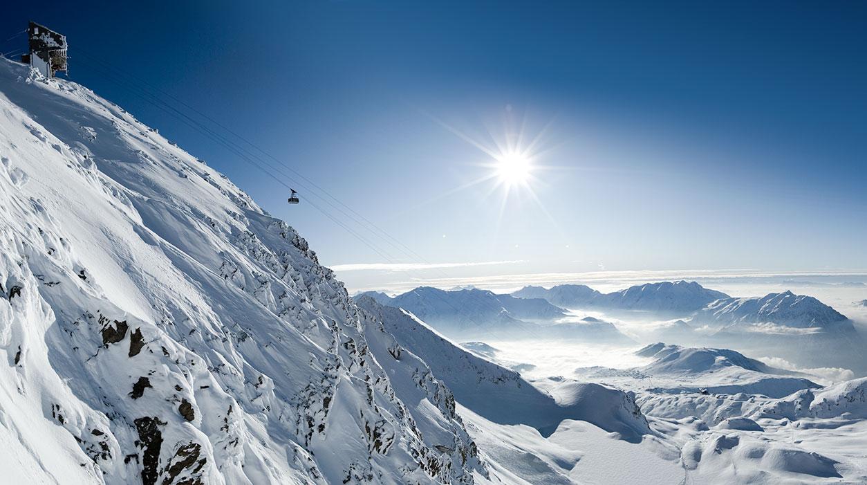 Gondola transporting skiiers to top of mountain in winter ski resort of Alpe D'huez