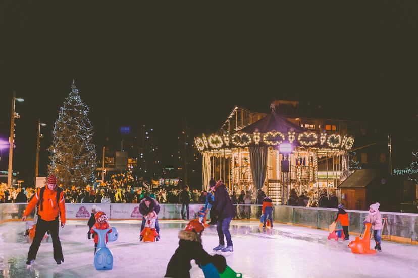 Groups of families enjoying ice skating in Morzine ski resort