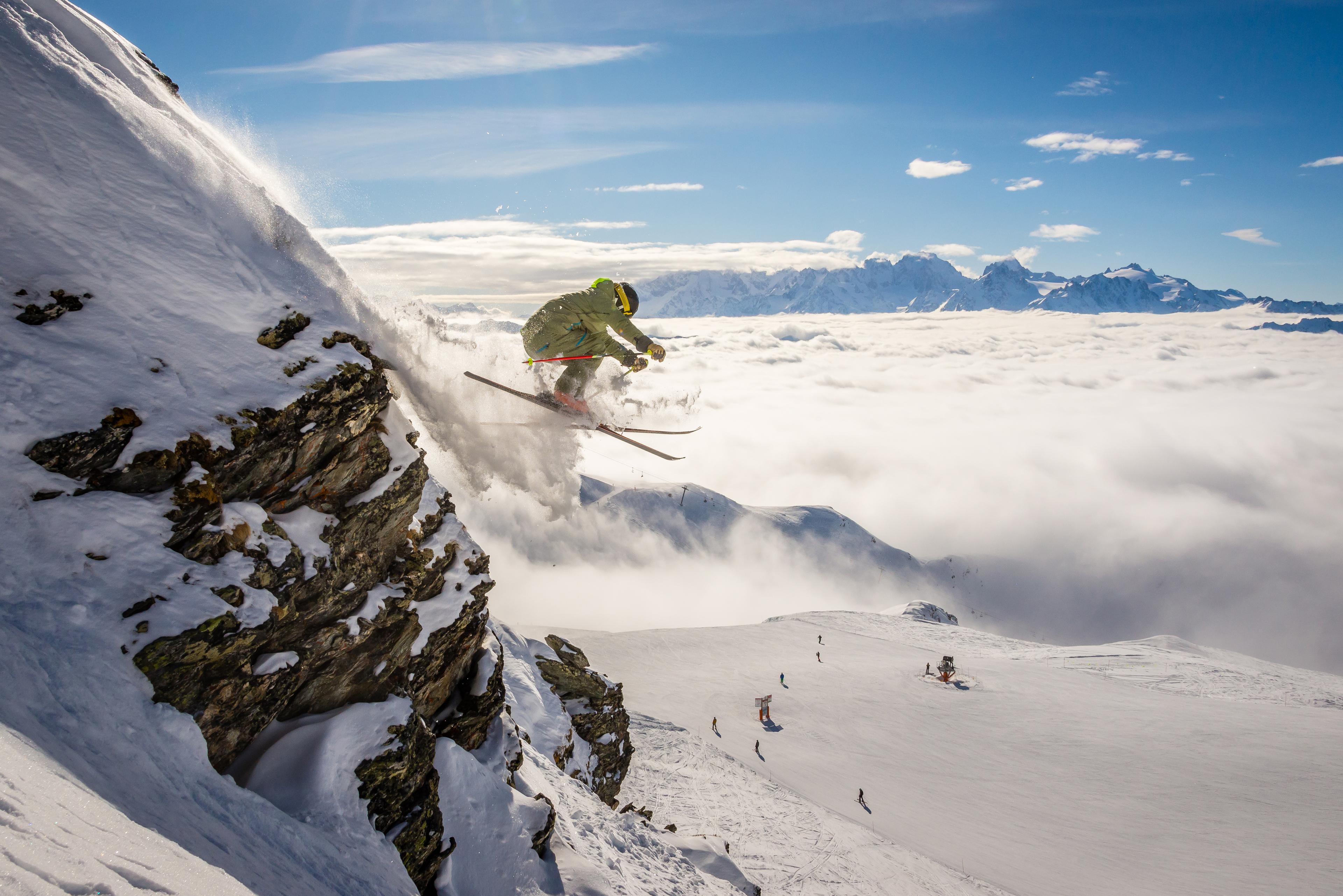 A male skier jumping off a rock, Verbier in the Swiss alps on a switzerland ski holiday